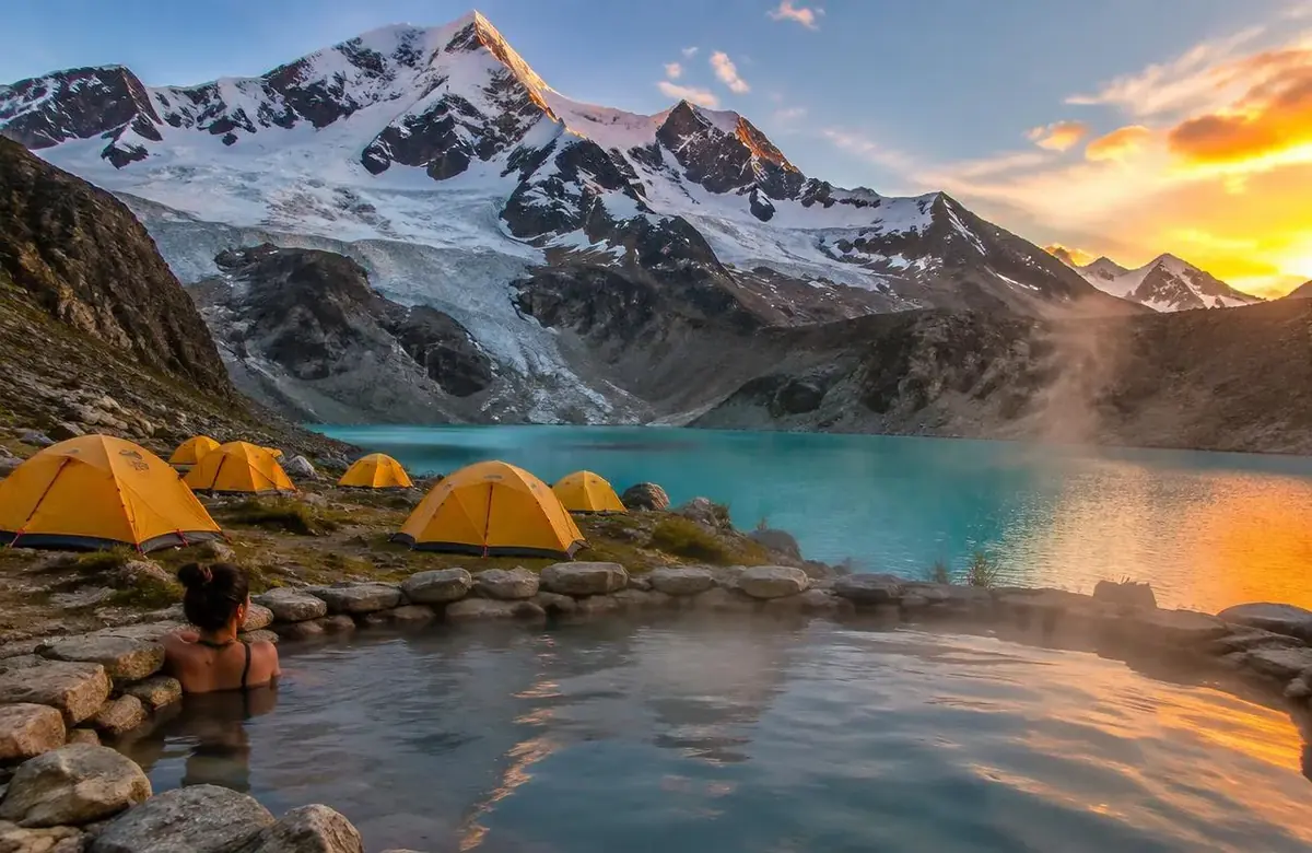 Tents beside a hot spring and turquoise glacier lake on the Ausangate trek, Peru