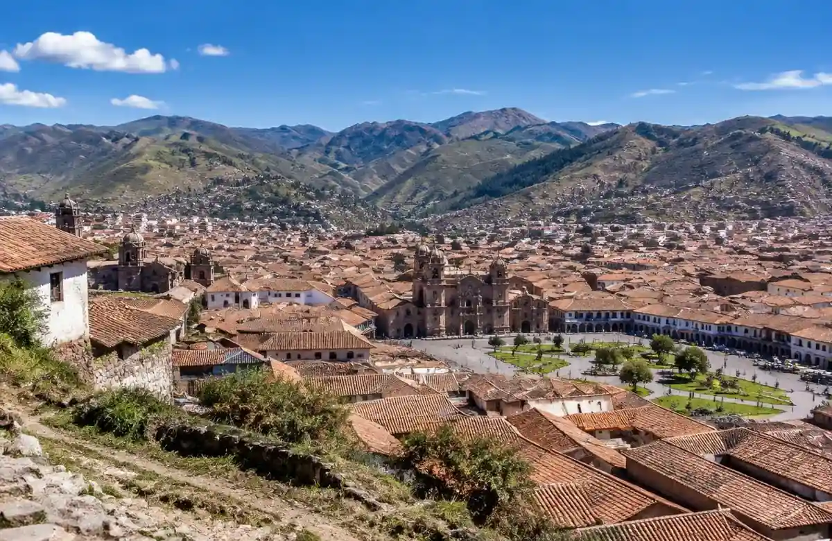 Cusco altitude view over red tile rooftops and the Plaza de Armas below Andes peaks