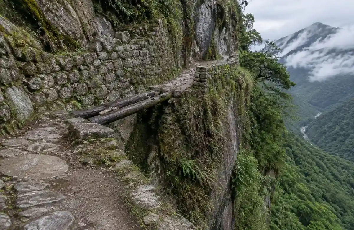 Inca Bridge at Machu Picchu, a cliffside stone trail with a log crossing
