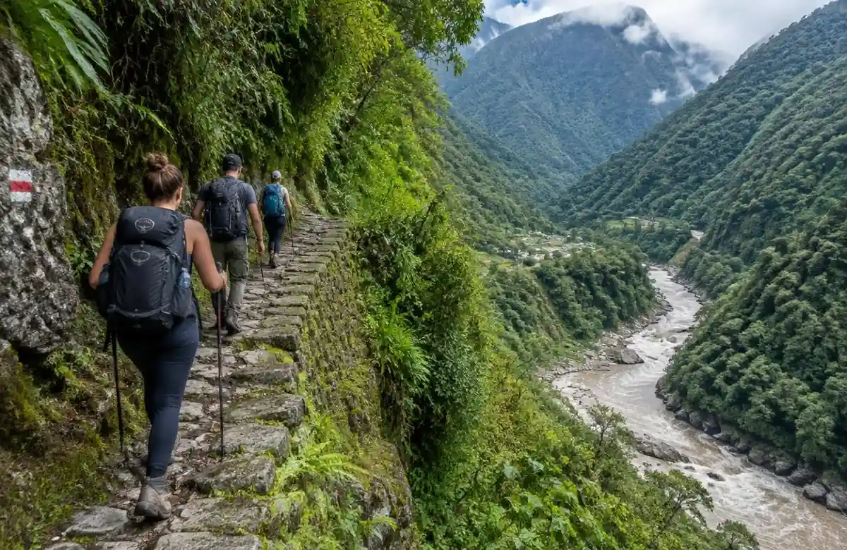 Hikers on a stone Inca path near Santa Teresa on the Inca Jungle trail