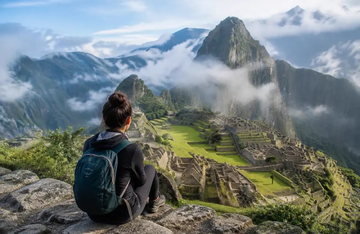 Solo backpacker sitting on a terrace enjoying machu picchu solo travel at sunrise