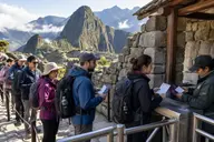 Visitors showing Machu Picchu tickets and passports to staff at the citadel entrance control gate
