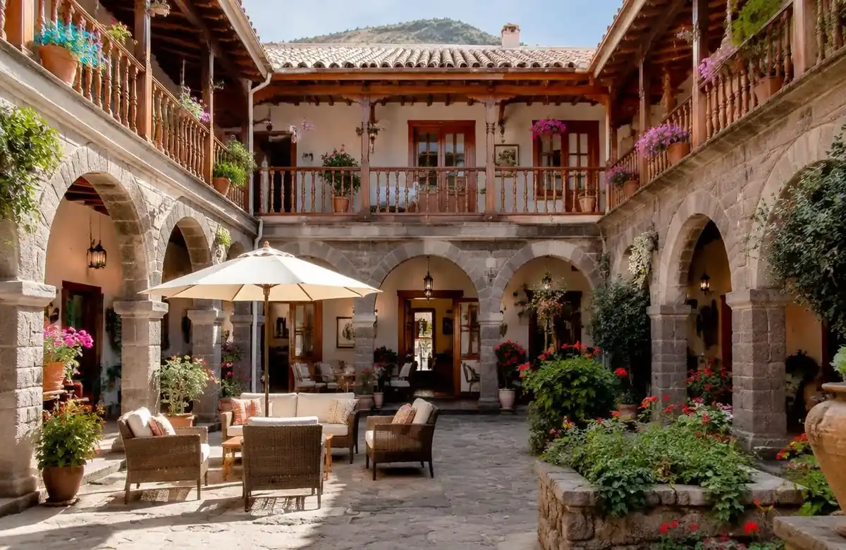 Colonial hotel courtyard with stone arches in Cusco included in a machu picchu vacation package