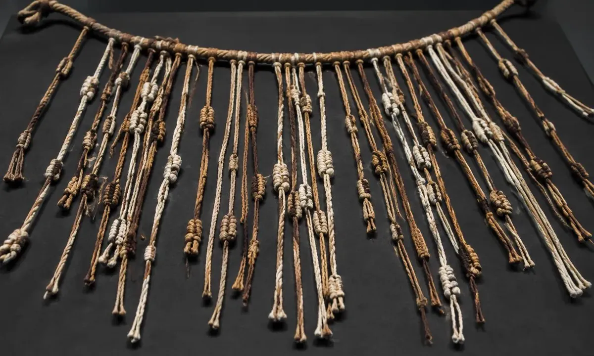 Inca quipu with knotted cotton and alpaca pendant cords on a museum display
