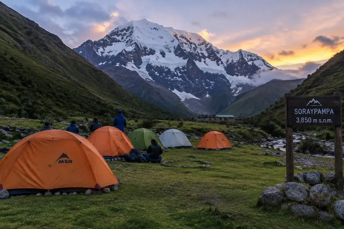 Campsite tents at Soraypampa on the Salkantay trekking route with snowy Salkantay mountain behind